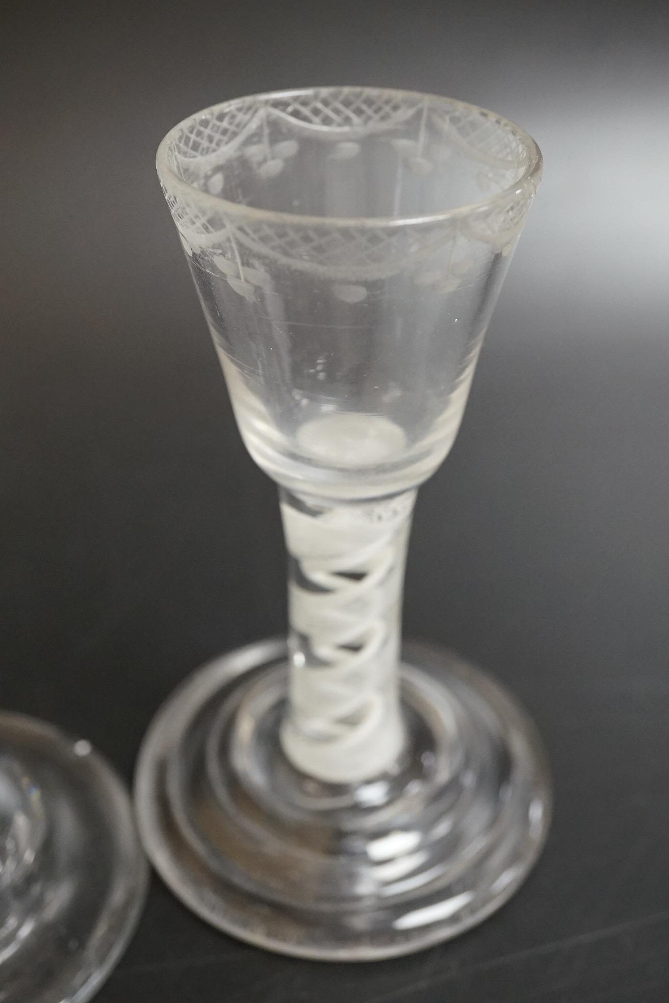 An opaque twist firing glass with terraced foot and a faceted wine glass with domed foot, c.1760, tallest 14cm
